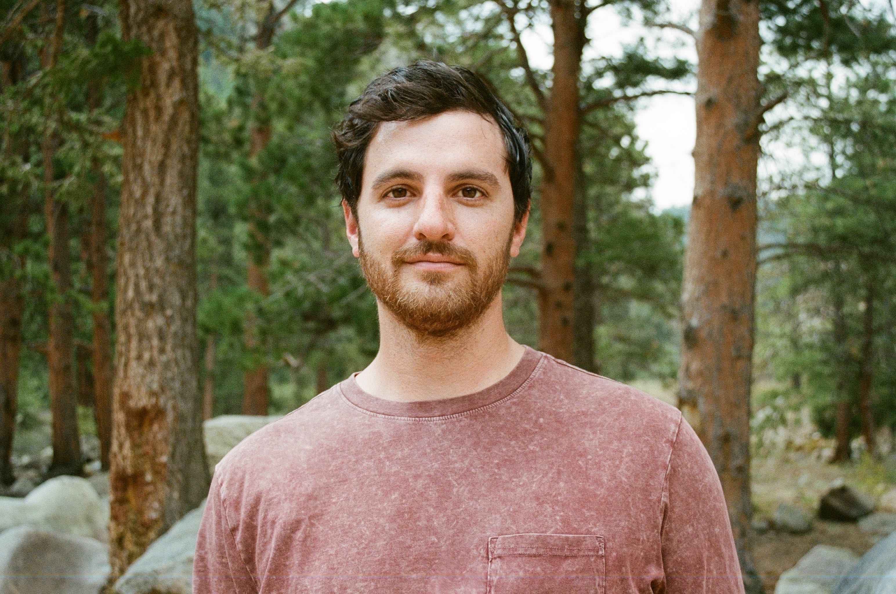 portrait photo of kenny with forest background